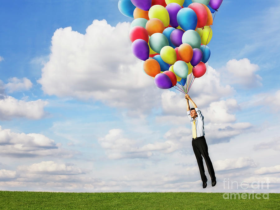 Man Holding Helium Balloons Photograph by Conceptual Images/science Photo Library