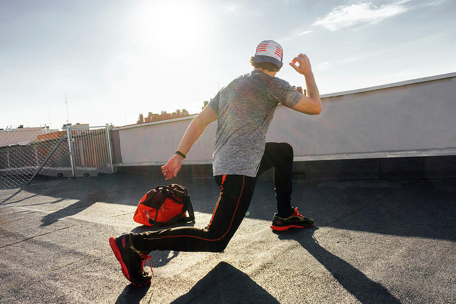 Man In Cap Training And Stretching Before Competing. Photograph by Cavan Images Fine Art America