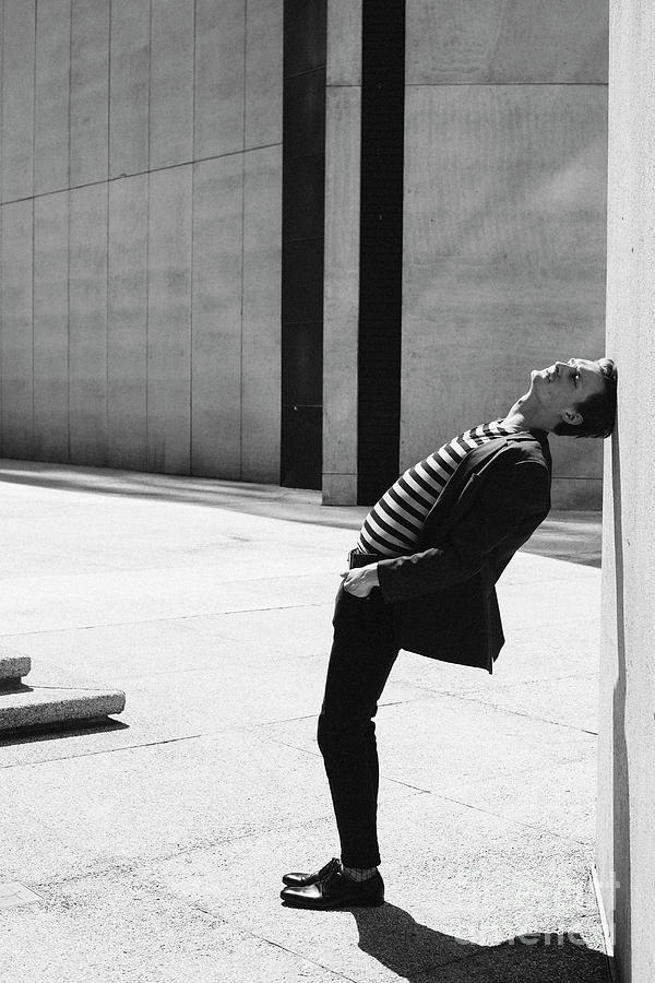 Man In Striped Shirt Leaning Head Against Wall Photograph by Caia Image ...