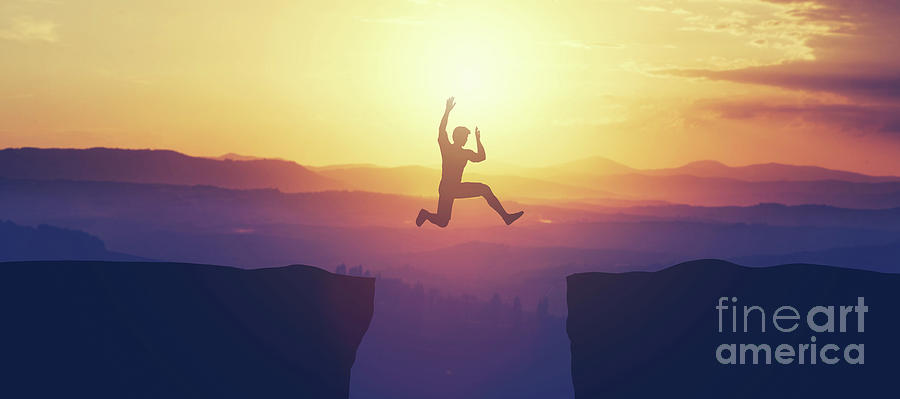 Man jumping above the cliff in the mountains. Photograph by Michal Bednarek