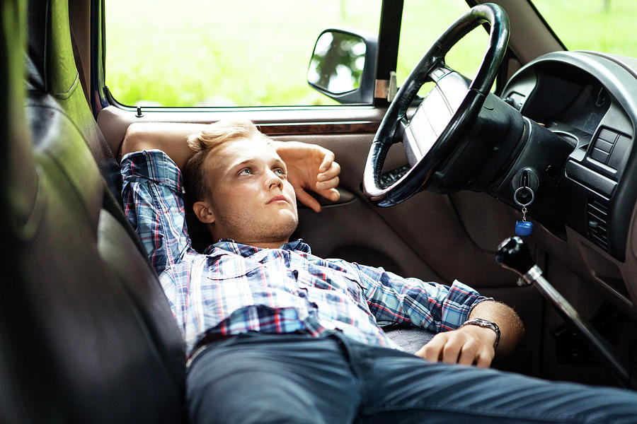 Man Looking Away While Relaxing In Pick-up Truck Photograph by Cavan ...