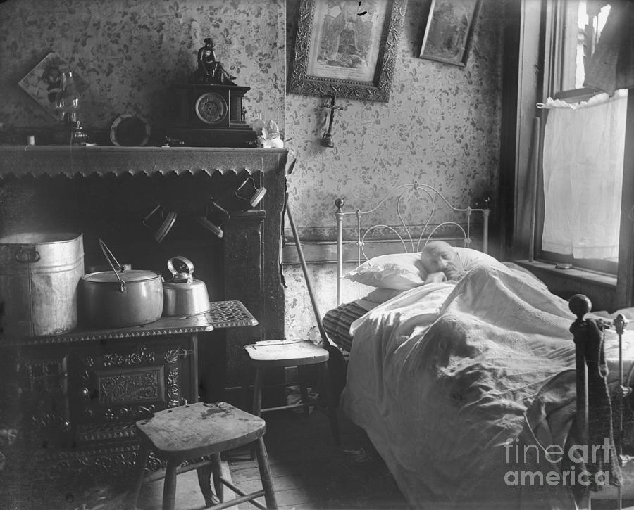 Man Lying In Bed In Tenement House Photograph by Bettmann