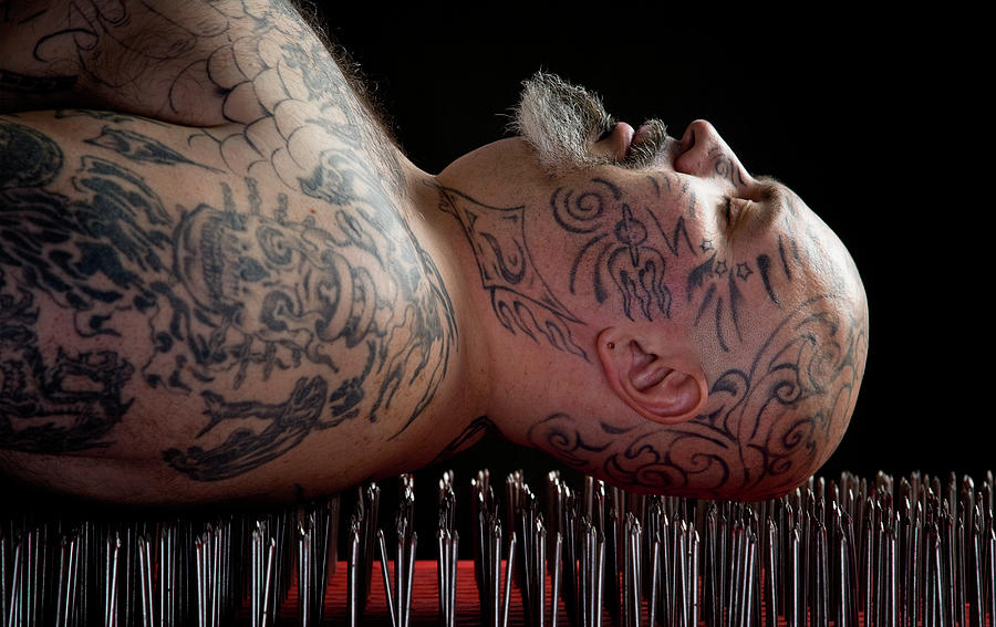 Man Lying On A Bed Of Nails Photograph by David Sacks