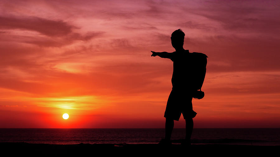 Sunset Photograph - Man On The Sunset After Help Baby Turttles Go To The Ocean by Cavan Images