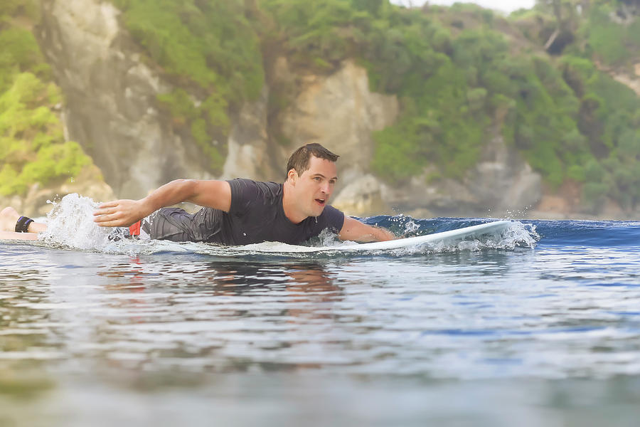 paddling a surfboard