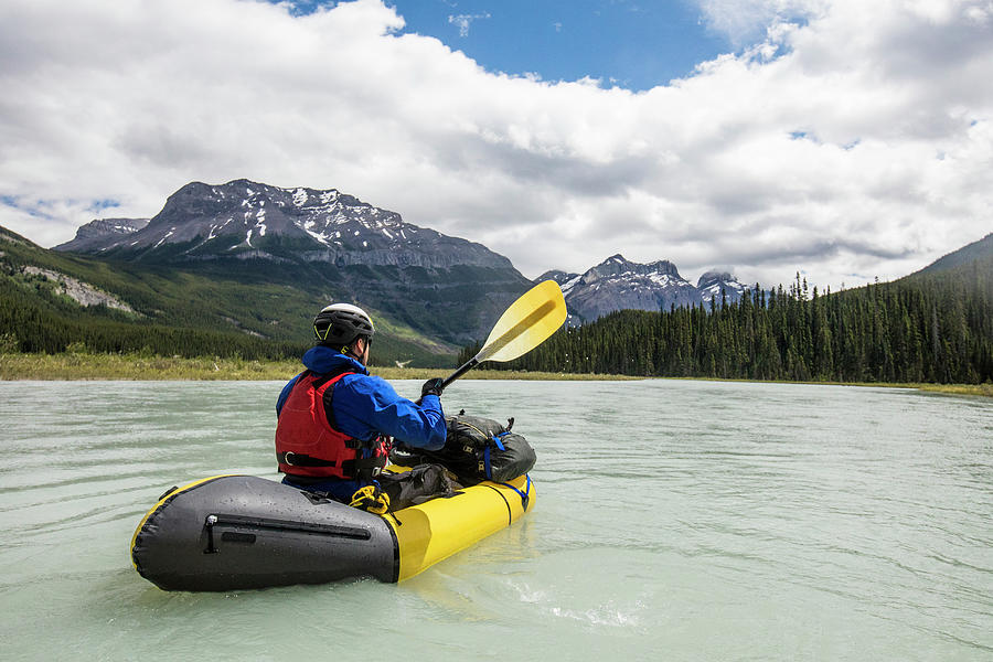 Man Paddling Yellow Raft Through Vast Valley In Banff National Park ...