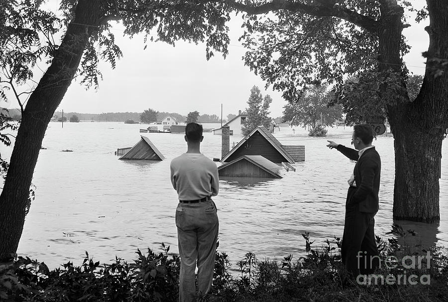Man Pointing To Attic Flooded By River Photograph by Bettmann