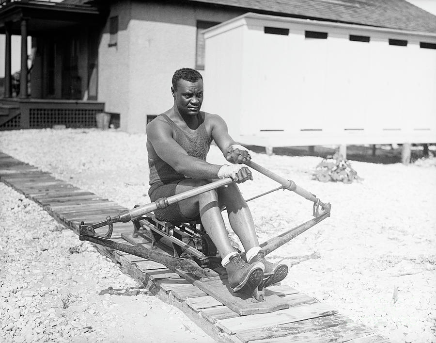 Man Practicing Rowing On A Machine Photograph by Bettmann
