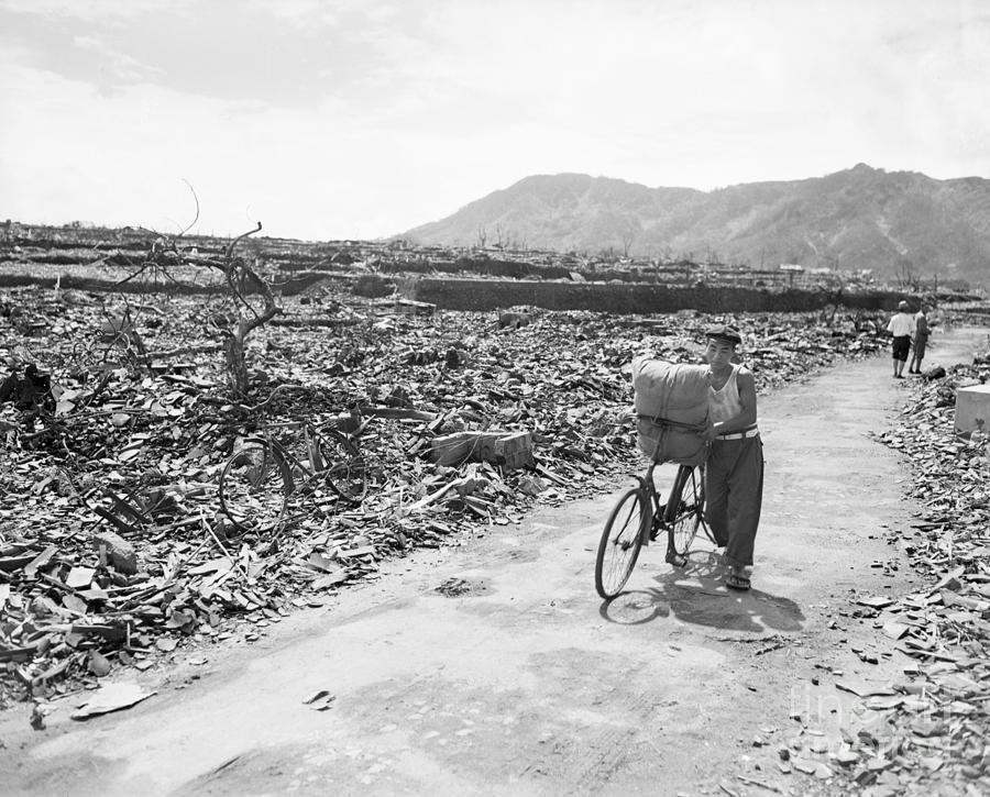 Man Pushing Bike Through Atomic Bomb Photograph by Bettmann