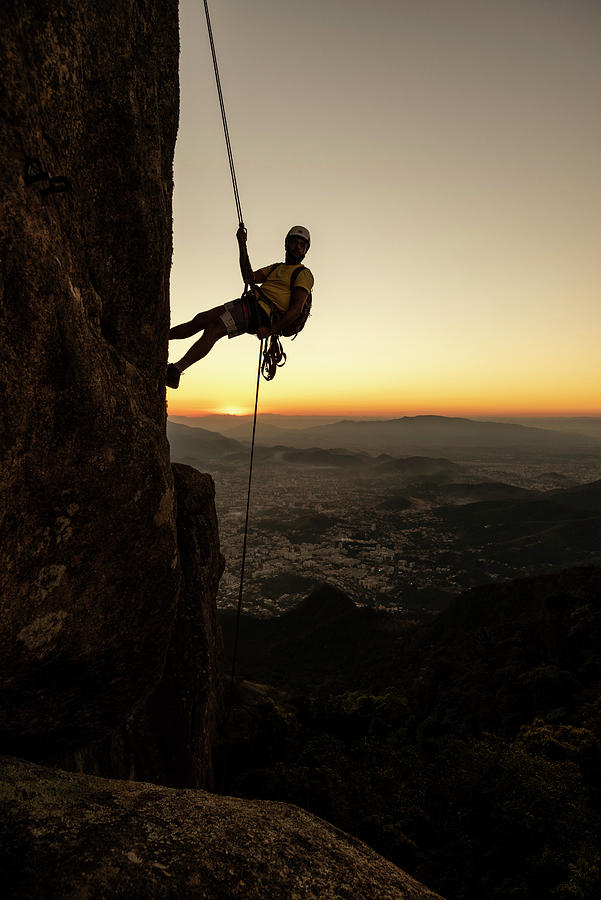 Man Rappelling Steep Rocky Mountain With Beautiful Dusk Golden Hour ...