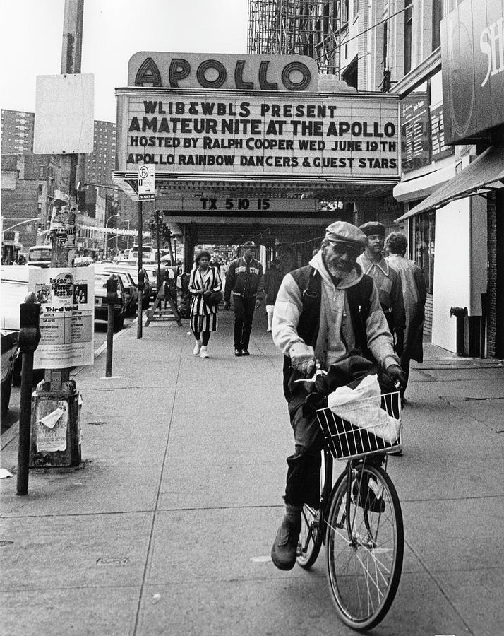 Apollo Theater Photograph - Man Rides Bike On Sidewalk In Front Of by The New York Historical Society