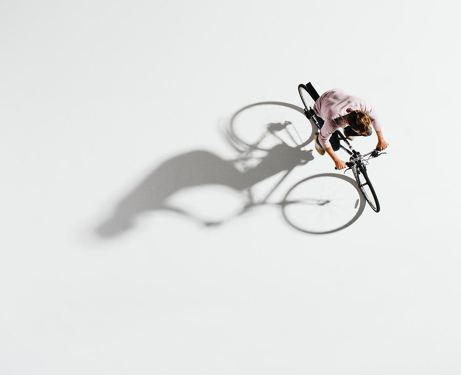 Man Riding Bicycle On White Background Photograph by Martin Barraud
