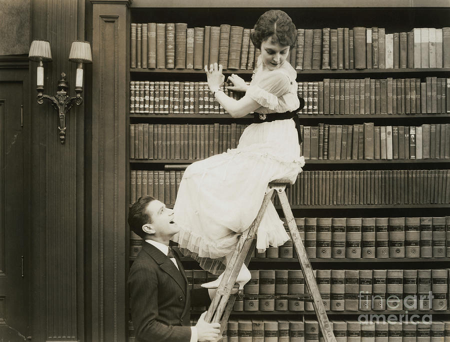 Man Shaking A Womans Ladder Photograph by Bettmann