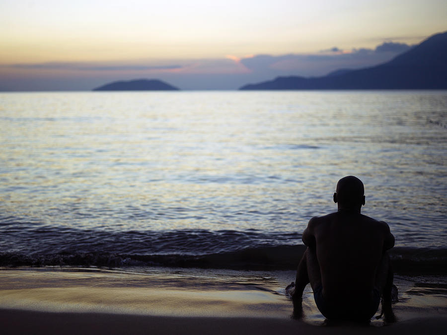 Man Sitting Alone On A Beach Photograph by Win-initiative/neleman