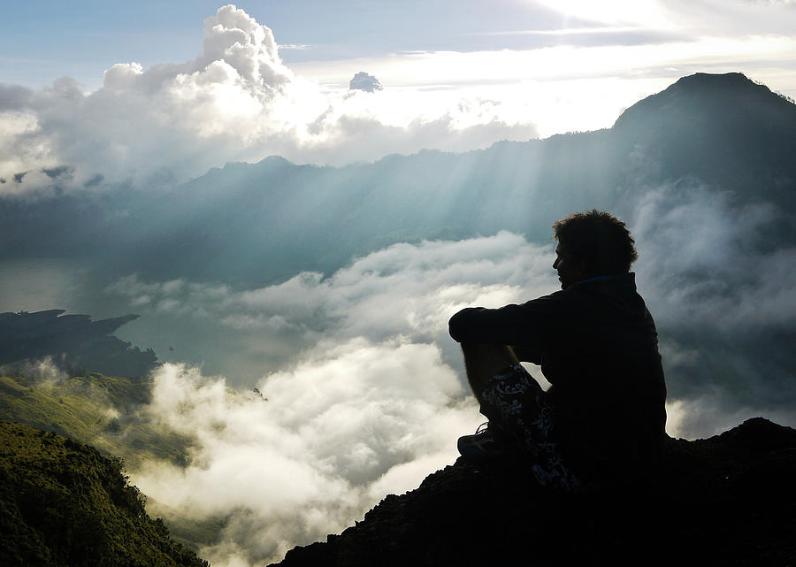 Man Sitting At Edge Of Rinjani Crater Photograph by Photography By Daniel Frauchiger, Switzerland
