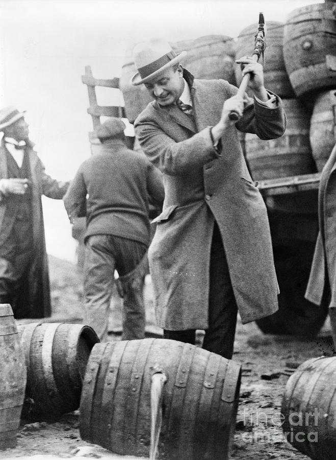 Man Smashing Keg Of Beer Photograph by Bettmann