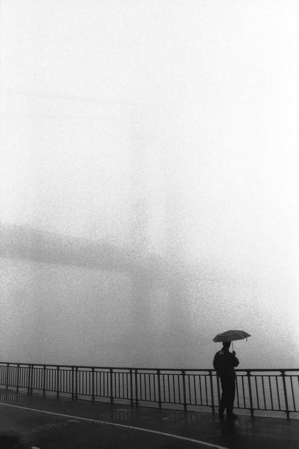 Man Stands With Umbrella Overlooking Photograph by New York Daily News Archive