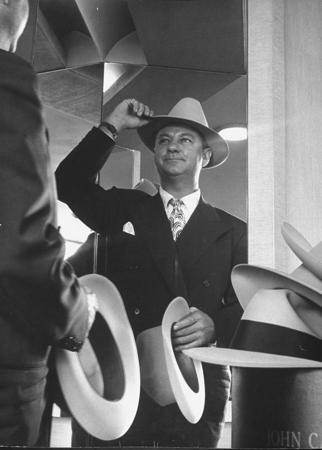 Man Trying On Hats At Nieman Marcus Depa Photograph by Nina Leen Man Trying On Hats At Nieman Marcus Depa Photograph by Nina Leen