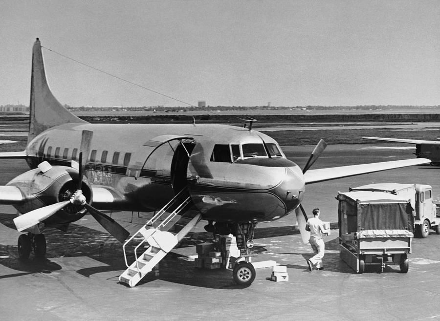 Man Unloading Cargo From Plane Photograph by George Marks