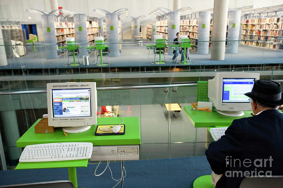 Man Using A Computer In A Public Library Photograph by Peter Menzel ...