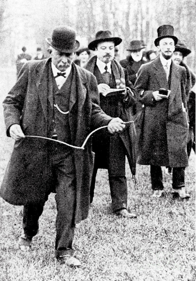 Man Using A Dowsing Rod In The Early 20th Century by Science Photo Library