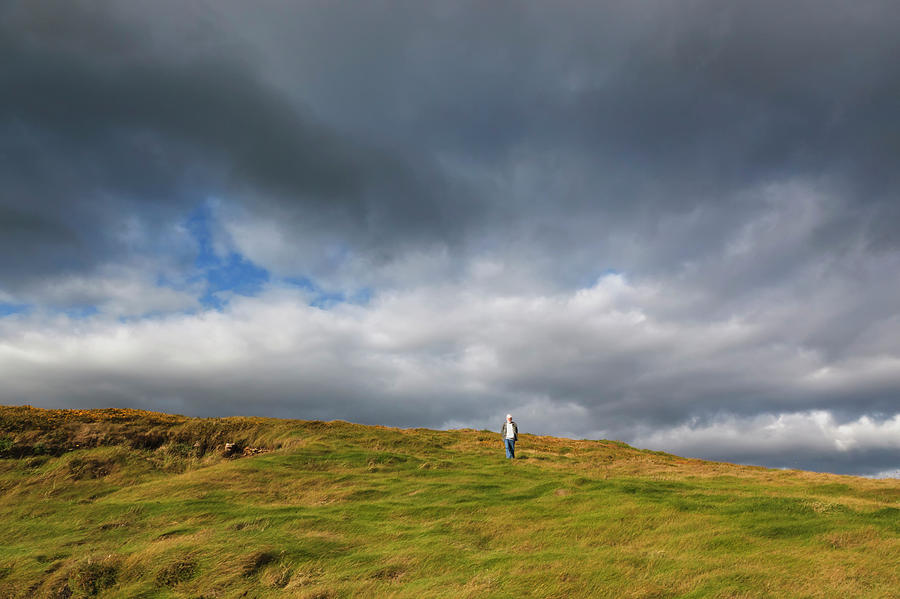 Man Walking Down The Hill At Galley Head Photograph by Ken Welsh / Design Pics