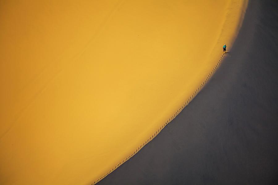 Man Walking Up Sand Dune In Desert Digital Art by Daniele Coppa