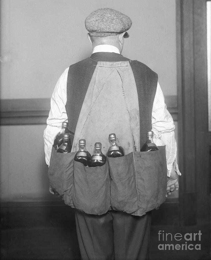 Man Wearing Coat Holding Bottles Photograph by Bettmann