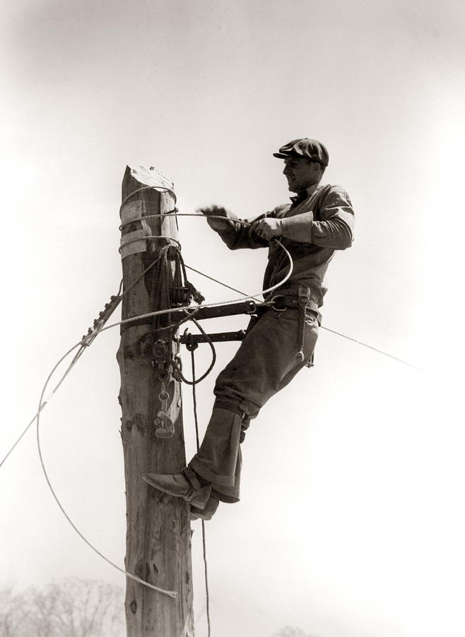 Man Worker, Working Atop Utility Pole Photograph by H. Armstrong Roberts