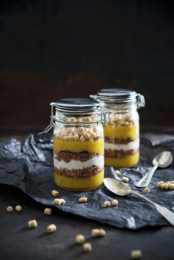 Mango And Apple Smoothie, Chocolate Coconut Muesli, Soy Yogurt And Oat Pops In Glass Jars Photograph by Kati Neudert