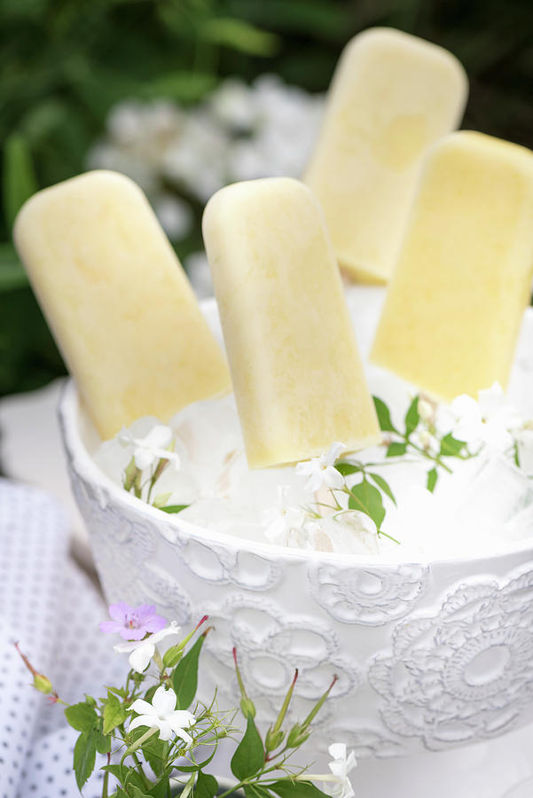 Mango And Lime Ice Lollies In An Ice Bucket Photograph by Winfried Heinze