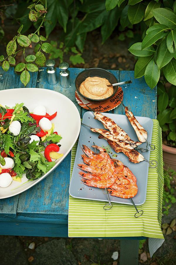 Mango Salad With Mini Mozzarella, Chicken Satay, Prawn Skewers And A Dip On A Table Outside Photograph by Jalag / Wolfgang Schardt