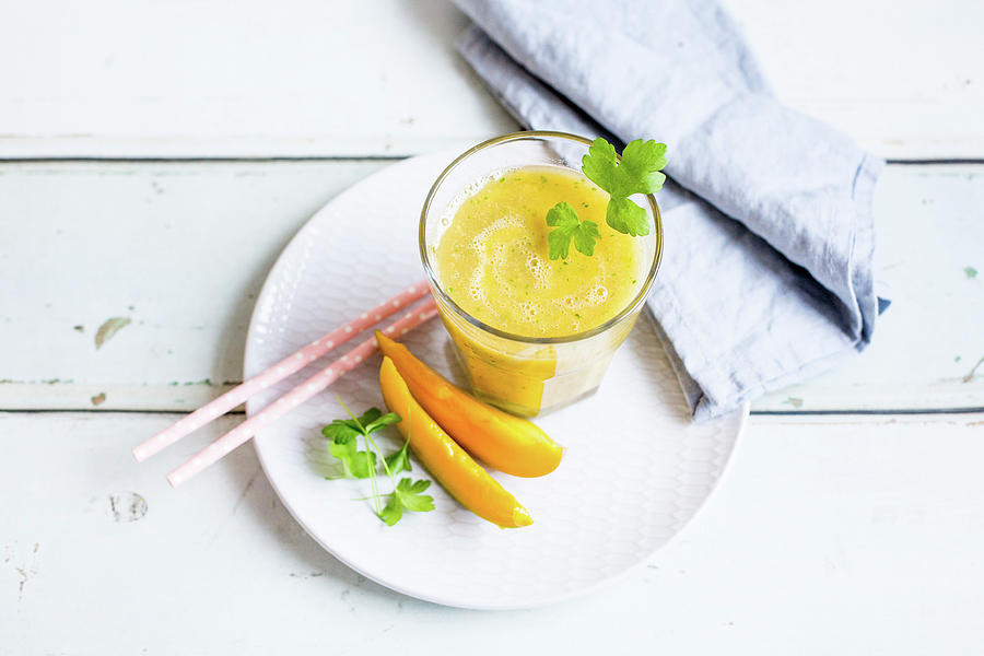 Mango Smoothie With Banana And Parsley Photograph by Claudia Timmann