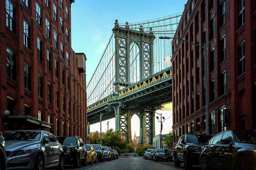 Manhattan bridge seen from a narrow alley enclosed by two brick  Photograph by Anek Suwannaphoom