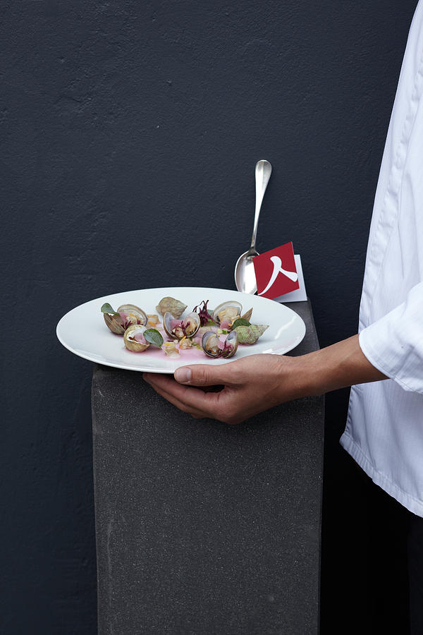 Mans Hand Holding Serving Dish With Mussels, Lemon Jelly And Oysters Herb Photograph by Jalag / Ulrike Holsten