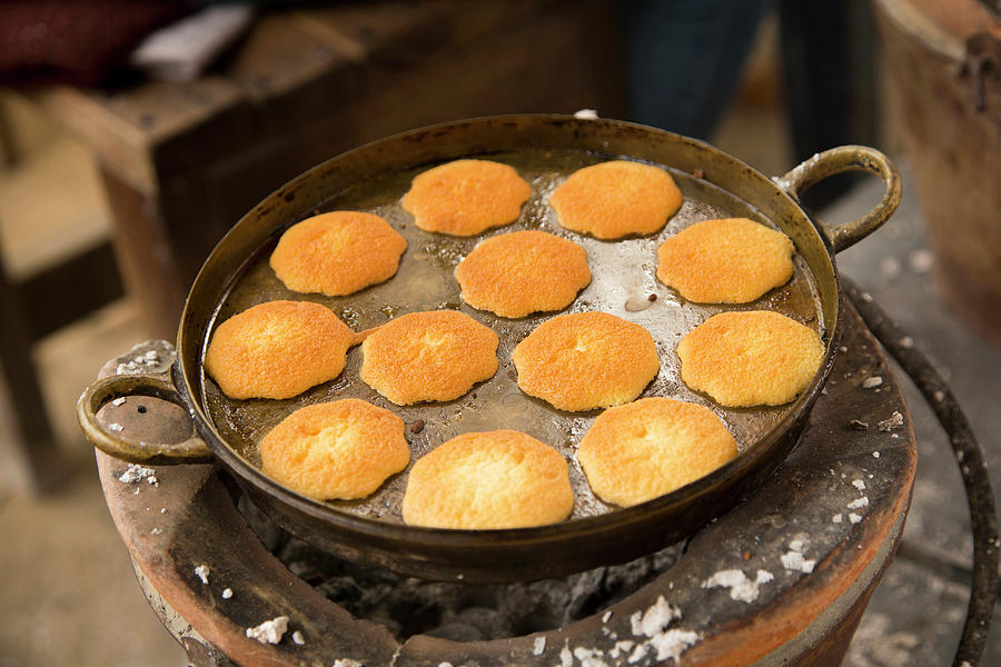 Many Egg Cakes In A Brass Pan On An Ancient Charcoal Stove, Samut Songhkram, Thailand Photograph by Albert Gonzalez