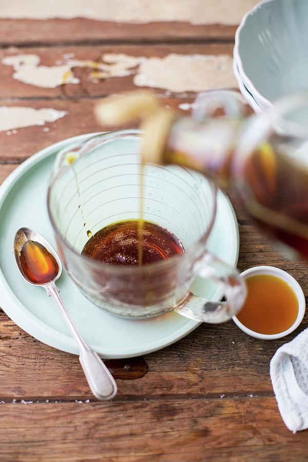 Maple Syrup Being Poured From Bottle Into A Glass Measuring Jug Photograph By Great Stock Pixels