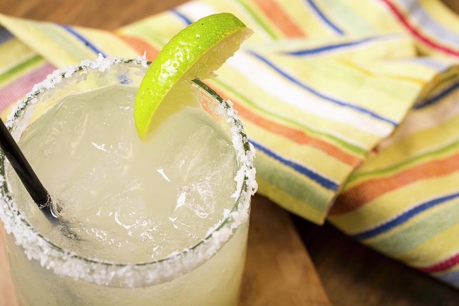Margarita In A Glass With A Slice Of Lime And A Salt-coated Rim Photograph by Farrell Scott