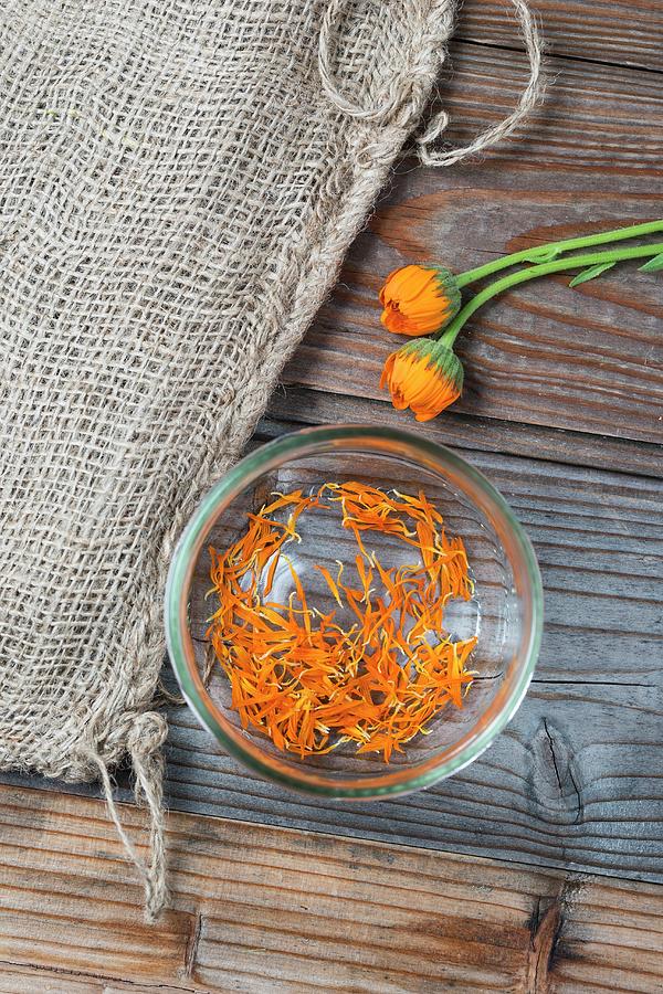 Marigold Petals In A Glass Bowl seen From Above Photograph by Mandy Reschke