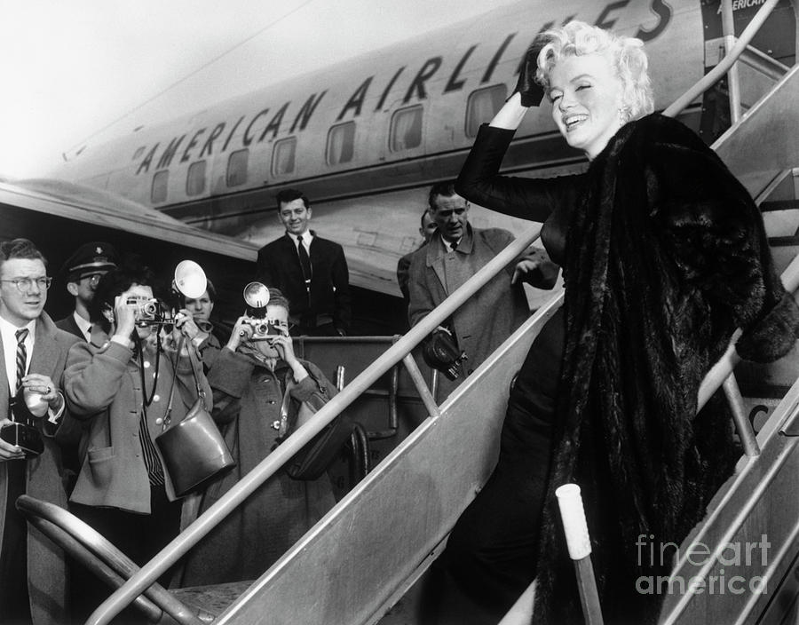 Marilyn Monroe Boards Airplane Photograph by Bettmann