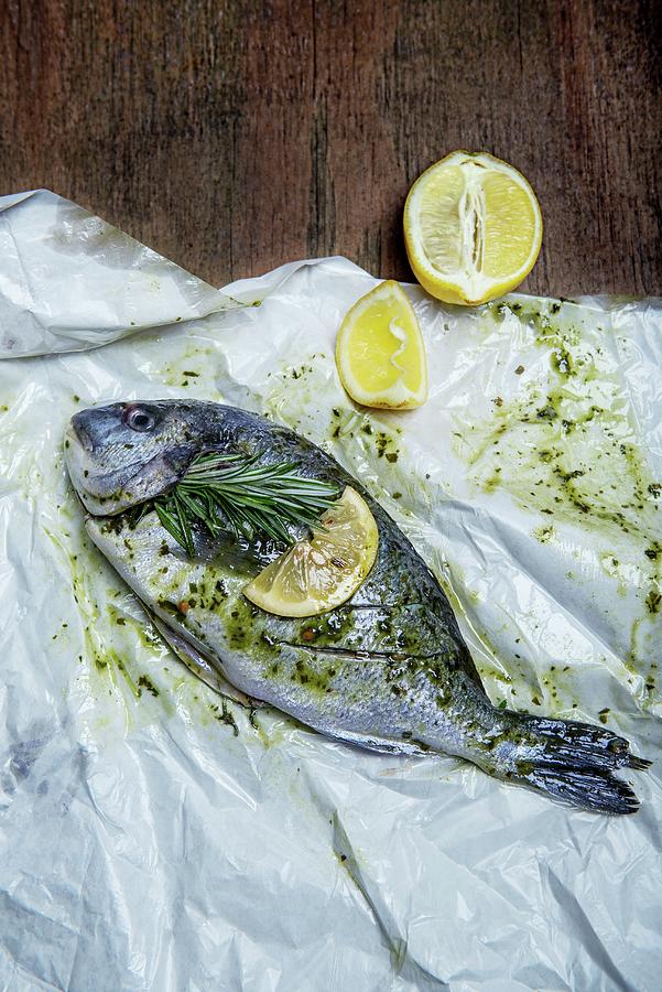 Marinated Gilthead With A Sprig Of Rosemary And Lemons Photograph by Angelika Grossmann