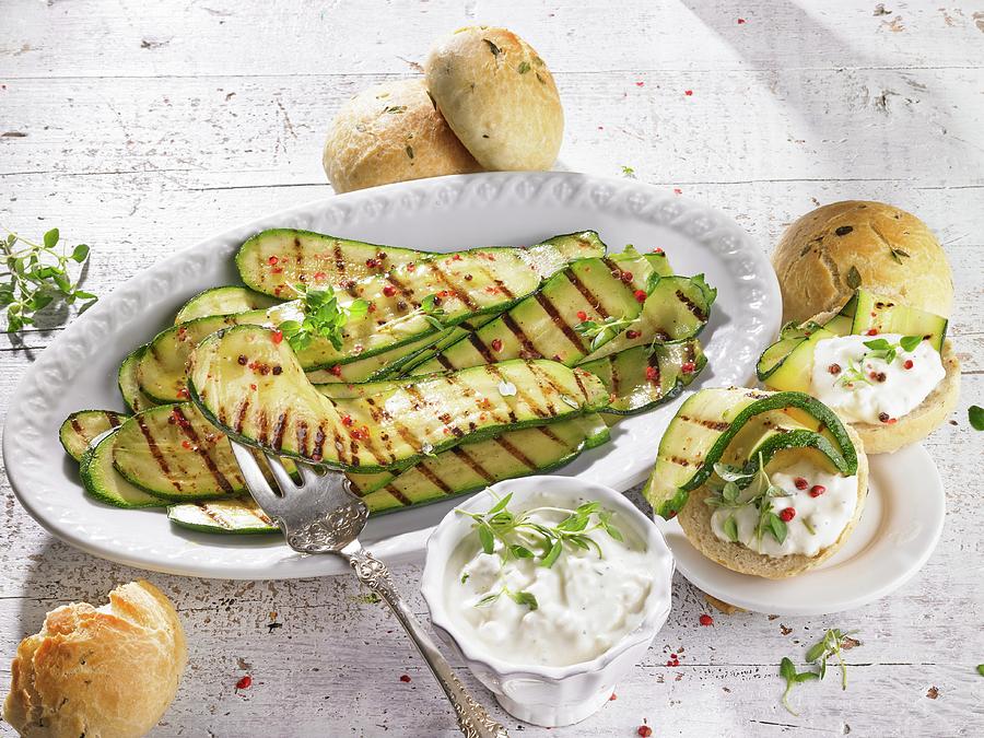 Marinated Grilled Courgettes With A Sheeps Cheese Sauce And Bread Rolls Photograph by Barbara Lutterbeck