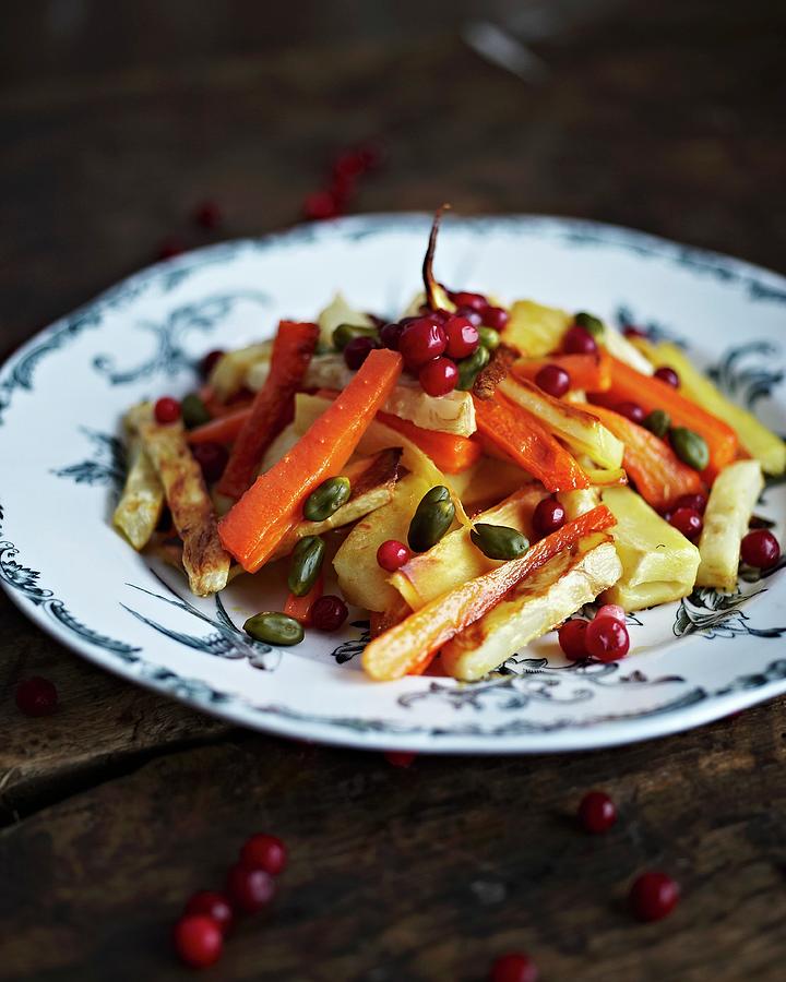 Marinated Roasted Root Vegetables With Pistachios And Lingonberries Photograph by Hannah Kompanik