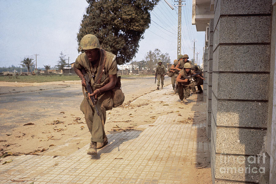 Marines Crouching Behind A Building Photograph by Bettmann