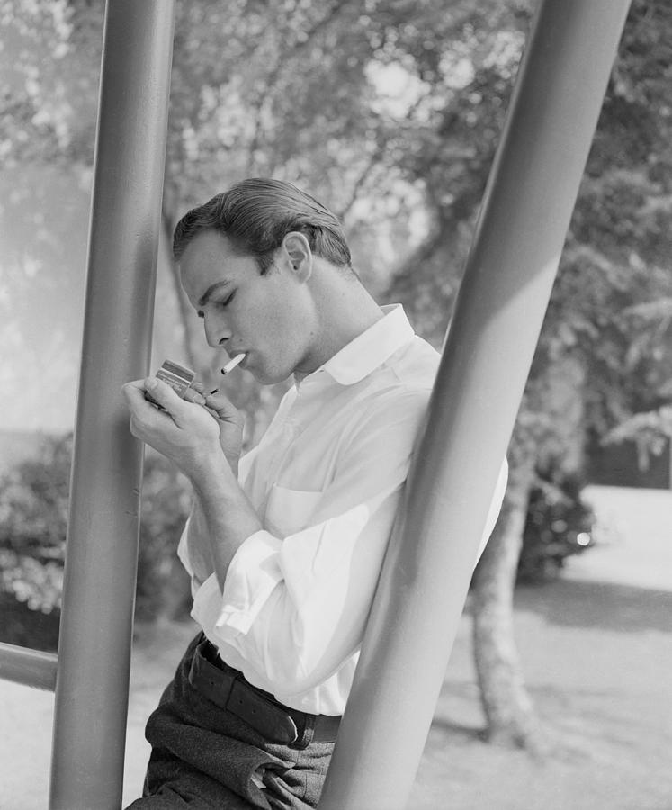 Marlon Brando Lighting A Cigarette Photograph by Bettmann