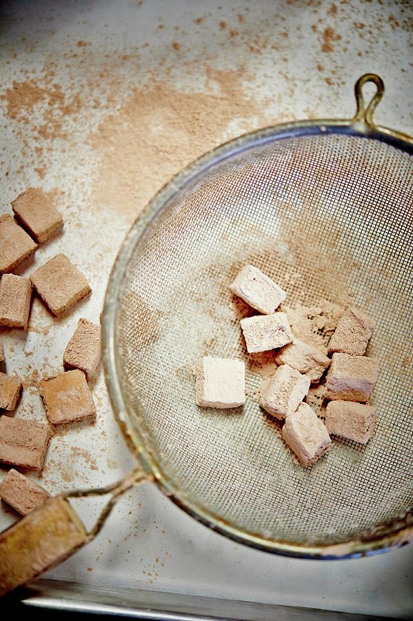 Marshmallows Being Dusted With Cocoa Powder Photograph by Greg Rannells