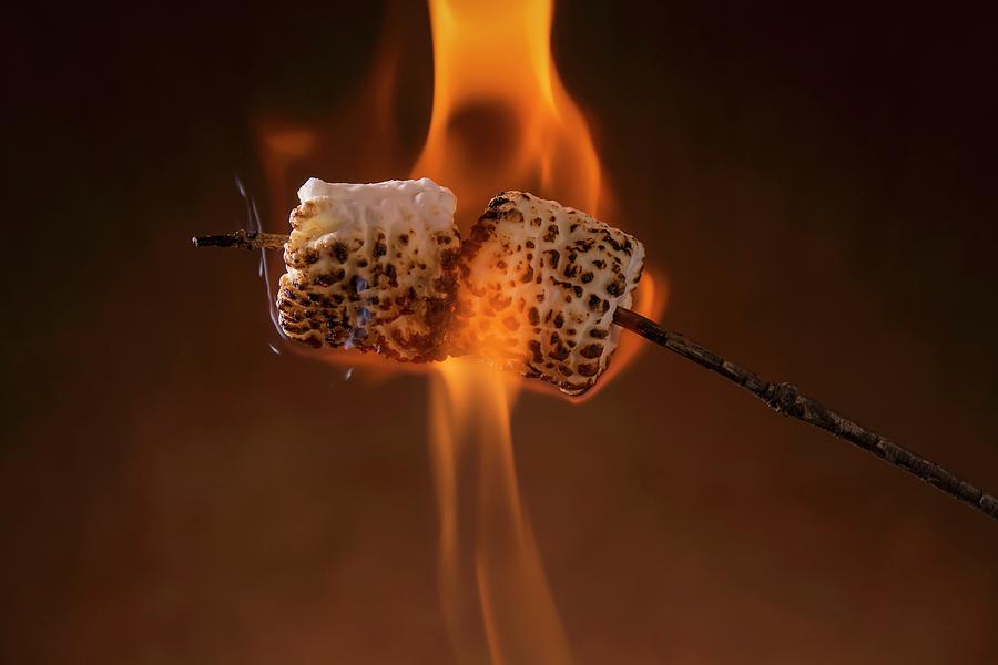 Marshmallows Being Toasted On A Stick Over A Flame Photograph by Brian Enright