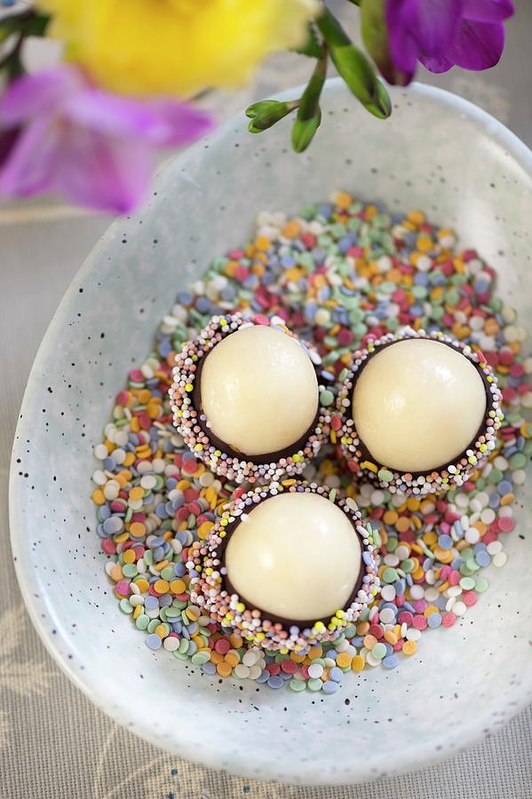 Marzipan Eggs With Chocolate Glaze And Sugar Sprinkles For Easter Photograph by Winfried Heinze