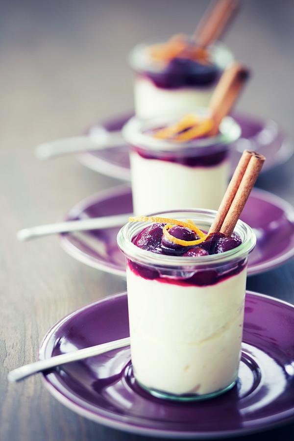 Marzipan Mousse With Mulled Wine Cherries In Glasses Garnished With Orange Zest And Cinnamon Sticks Photograph by Jan Wischnewski
