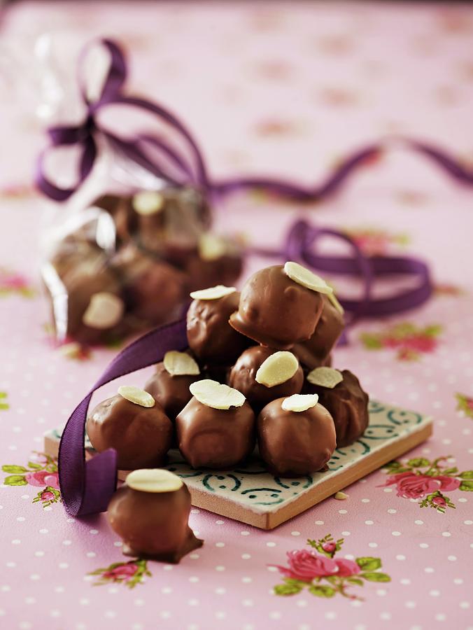 Marzipan Pralines With Chocolate Glaze And Flaked Almonds Photograph by Mikkel Adsbl